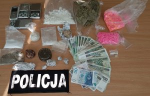 narkotyki, pieniądze, plakietka z napisem Policja